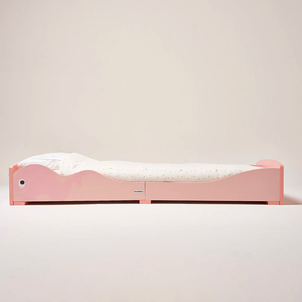  a pink bed low to the ground Montessori